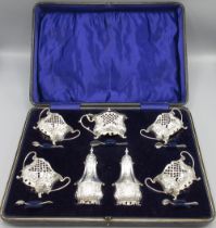 Edward V11 silver Rococo Revival seven-piece cruet set, decorated with scrolls, pierced and cross