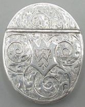Victorian silver oval vesta case, all over engraved with scrollwork, hinged lid with initials in