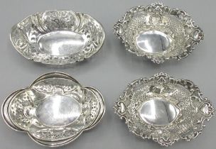 Pair of Edward V11 silver oval bon-bon dishes, geometric pierced sides with scroll cast borders,