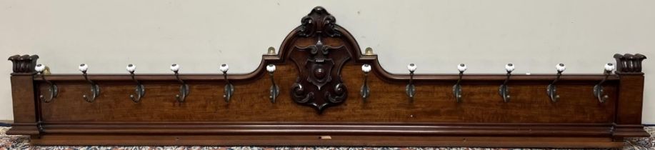 Large Victorian Country House mahogany coat rack, with carved shield cresting, twelve brass hooks