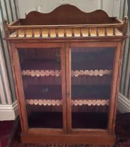 Edwardian golden oak bookcase, galleried top with arched cresting above a pair of glazed doors,