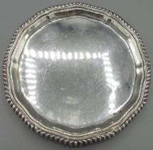 George V silver circular waiter, with gadrooned border on three claw and ball feet, Josiah