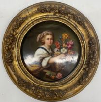 19th century KPM porcelain circular plaque, painted with a young girl holding a flower filled