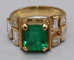 18ct yellow gold diamond and emerald ring by Susan Wright, the central emerald cut emerald in claw