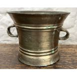 Large bronze mortar, banded bell-shaped body with two lug handles, H14cm W20cm max