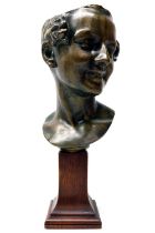 Early 20th century patinated bronze mask of a young woman, mounted on wooden plinth, H42cm
