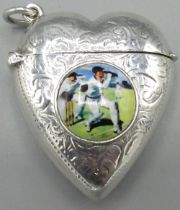20th century continental silver heart shaped vesta case, decorated with a cricket scene on a