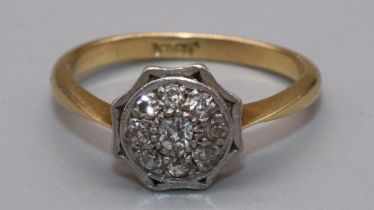 Yellow gold diamond cluster ring, the central round cut diamond surrounded by a halo of smaller