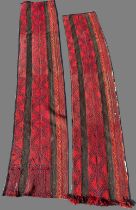 Pair of 20th century red ground Caucasian wool runners with central geometric repeating zig zag