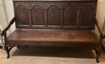 George 111 oak tavern settle, raised back with five fielded panels, solid seat with shaped arms