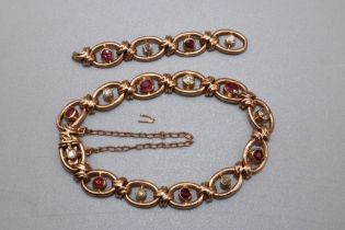 15ct yellow gold oval link bracelet set with diamonds and rubies, with box closure and safety chain,