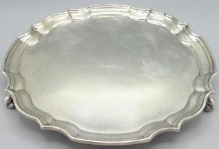 George V1 silver octagonal salver with raised piecrust border on three scroll feet, Harrison