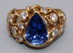 18ct yellow gold sapphire and diamond ring by Susan Wright, set with central pear cut sapphire, on