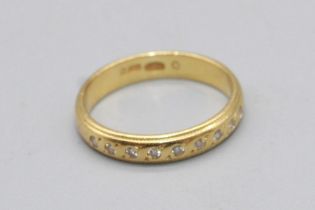 18ct yellow gold band ring, half inset with brilliant cut diamonds, stamped 750, size I1/2, 2.6g