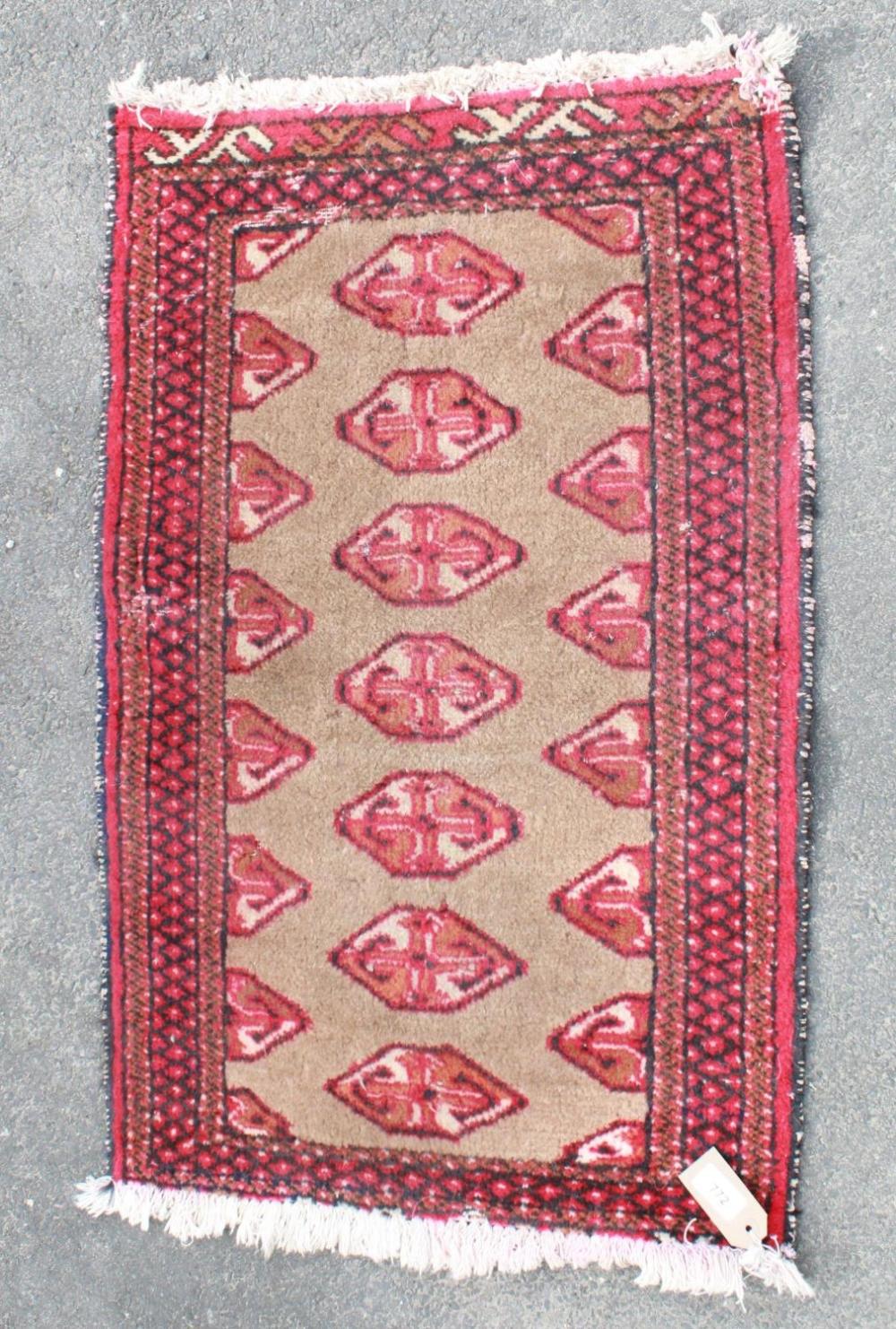 C20th Caucasian wool prayer rug, brown field with elephant's foot pattern, red geometric pattern
