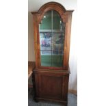 Queen Anne style walnut arched top side cabinet, with glazed upper and panel lower doors on