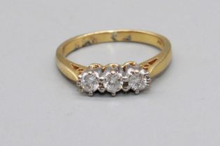 18ct yellow gold three stone diamond ring, stamped 750, 3.2g