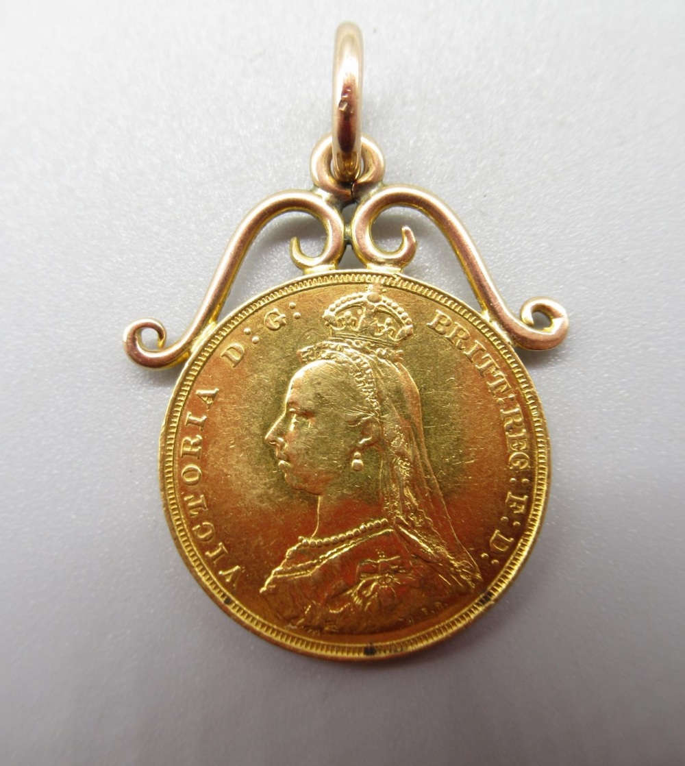 Victoria 1887 sovereign, attached to yellow metal scroll mount, 9.3g