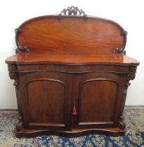 Victorian mahogany serpentine front Chiffonier, arched back with carved cresting above two doors