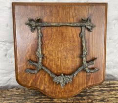 Unusual Edwardian oak wall mounted letter rack with hinged oak leaf and branch cast bracket, W25cm