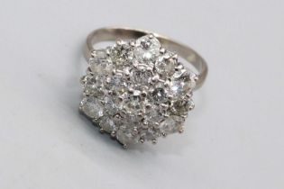 White metal diamond cluster ring, set with nineteen brilliant cut diamonds, stamp worn but