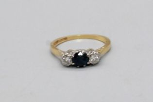 18ct yellow gold and platinum diamond and sapphire ring, the central sapphire flanked by diamonds,