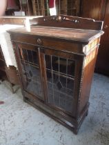 C20th oak display cabinet, arched back and two lead glazed doors on turned supports with stretchers,