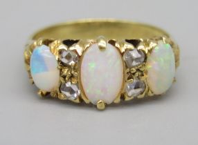 18ct yellow gold opal and diamond ring, the three cabochon opals separated by brilliant cut