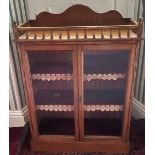 Edwardian golden oak bookcase, galleried top with arched cresting above a pair of glazed doors,