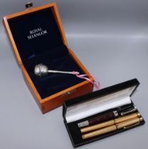 Two Sheaffer gold plated pens with 14k nibs, one other pen, and a Royal Selangor pewter baby's