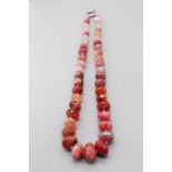 Pink cut stone necklace set with cut agate, quartz etc. on pink double-knotted thread, with white