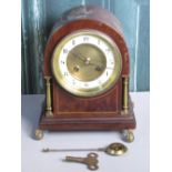 Edwardian inlaid mahogany arched top mantle clock with circular Arabic chapter, brass columns and