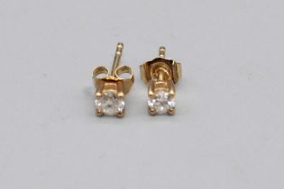 Pair of 9ct yellow gold diamond stud earrings, stamped 375, 0.6g