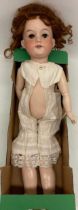 Early 20th century Armand Marseille bisque head doll, curled wig, white undergarments, marked 390n/