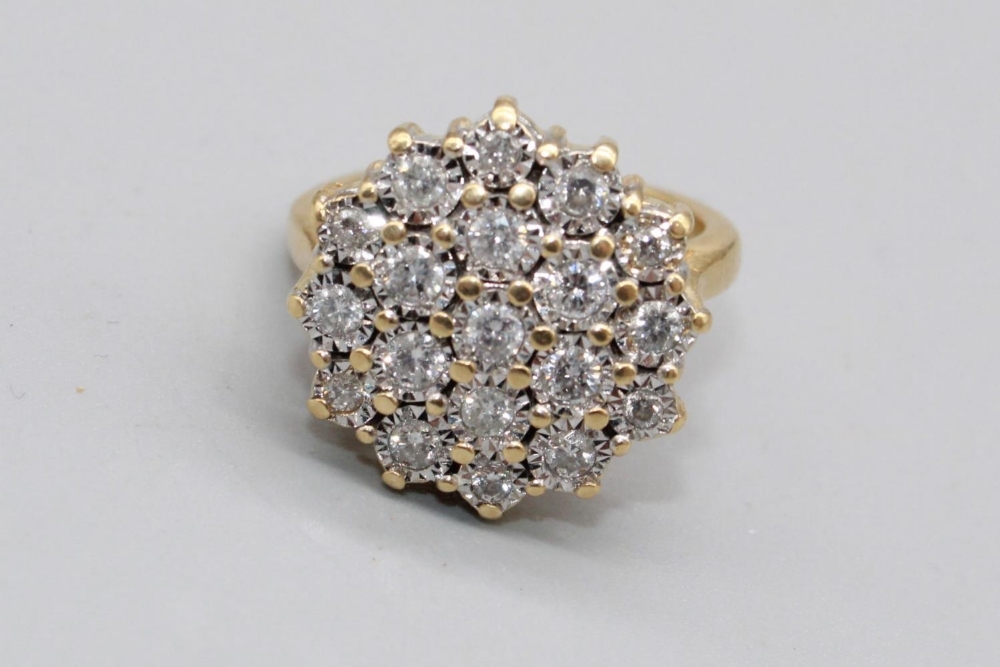 18ct yellow gold diamond cluster ring set with nineteen brilliant cut diamonds in illusion settings,
