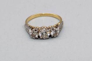 18ct yellow gold three stone diamond ring, on diamond set shoulders, stamped 18, size J, 3.0g