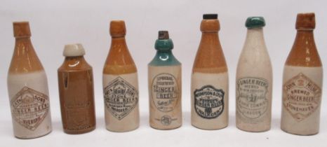 Collection of early 20th century stoneware ginger beer bottles, predominantly Scottish, one of