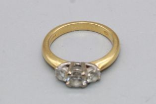 18ct yellow gold three stone diamond ring set with a large central diamond flanked by two smaller