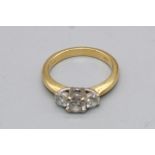 18ct yellow gold three stone diamond ring set with a large central diamond flanked by two smaller