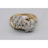 18ct yellow gold double floral cluster ring, each cluster set with seven brilliant cut diamonds in