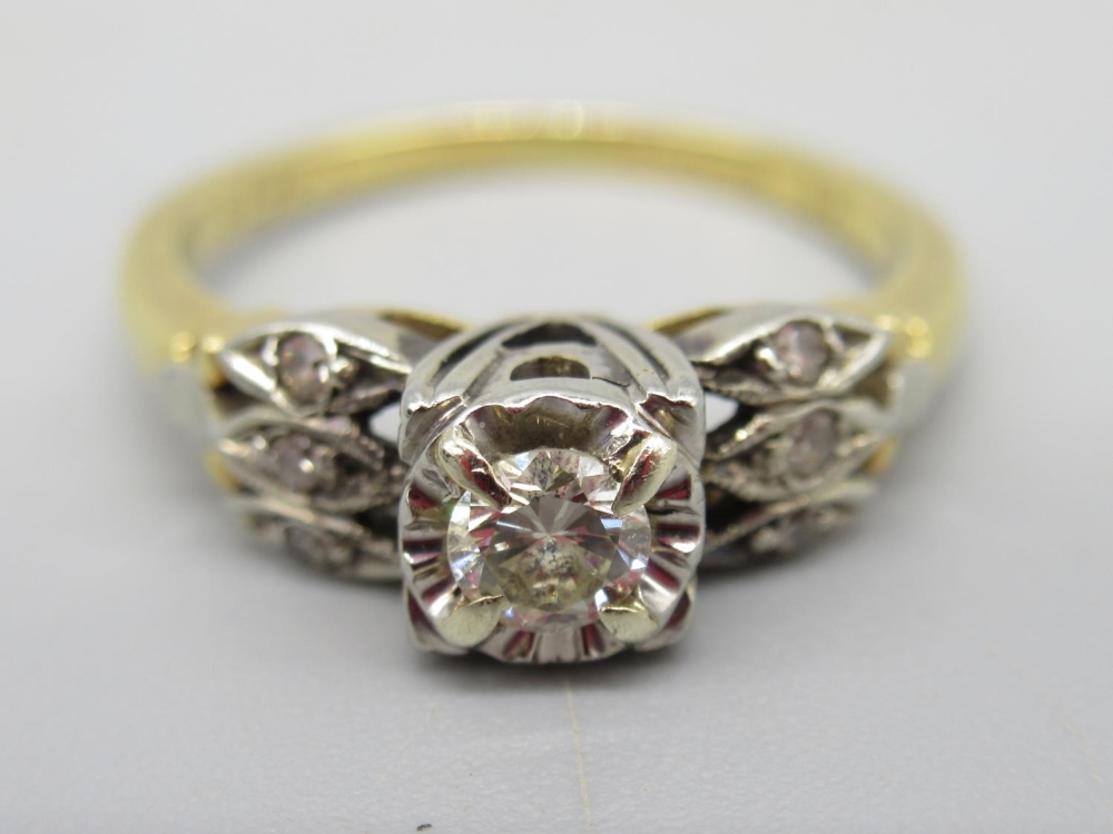 18ct yellow gold diamond ring, the round cut central diamond in white gold square mount, on triple