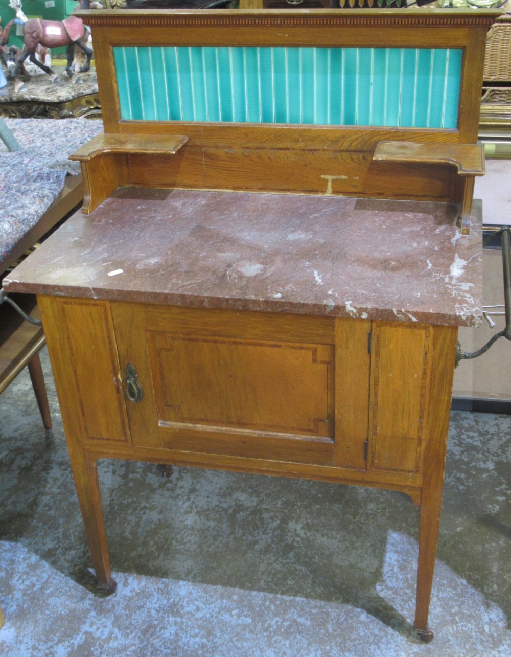 Edwardian inlaid oak and walnut marble top washstand, with tiled back and cupboard on square tapered