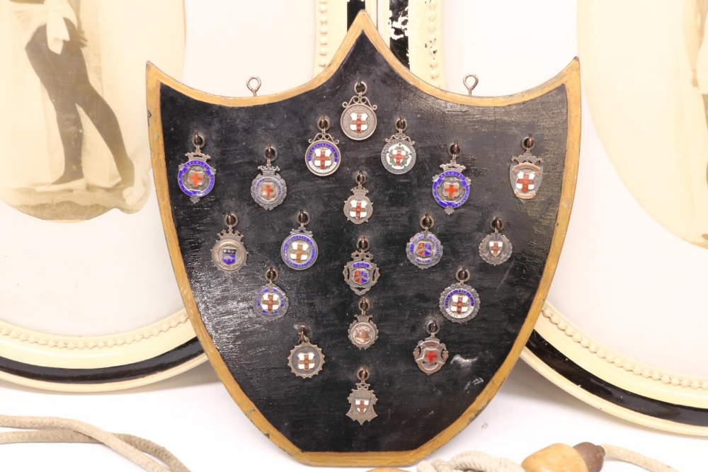 Collection of early 20th century silver and enamel gymnastics medals mounted on shield shaped board, - Image 2 of 2