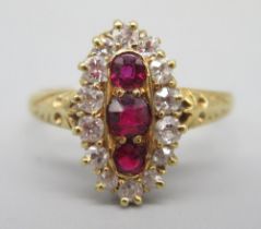 18ct yellow gold ring set with three brilliant cut red spinels surrounded by diamonds, on ornate