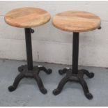 C20th pair of cast iron machinist type stools with circular beech height adjustable seats, minimum