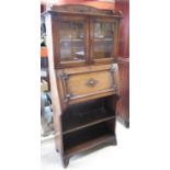 C20th Ray & Miles oak bureau bookcase, two lead glazed doors above fall front and two shelves, W77cm