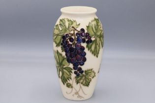 Moorcroft Pottery: 'Grapevine' vase designed by Sally Tuffin for M.C.C. c1987, purple grapes on