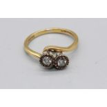 18ct yellow gold and platinum two stone diamond crossover ring, the round cut diamonds in illusion