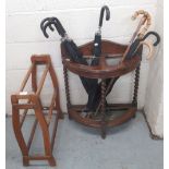 Oak barley twist demi lune stick stand, H75cm W56cm, with contents comprising six umbrellas, and two