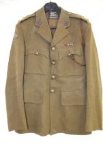 A WW2 Captain's uniform by Burberry's. Insignia and cap badge suggest membership of the Royal